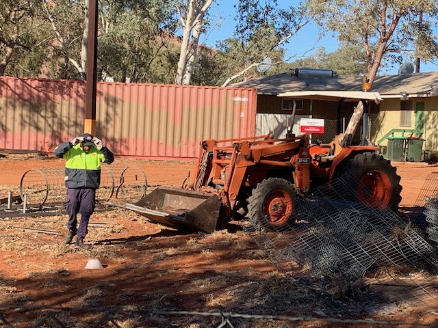 Image: Cleaning up community at Docker River. Man and digger in image.