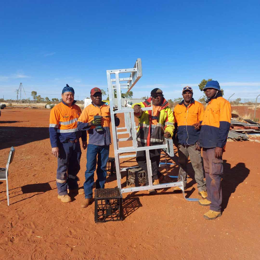 What we do - A group of men working holding a steel frame